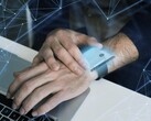 A smartwatch near a computer, hinting at potential security risks (Image source: Freepik)