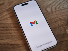An iPhone with the Gmail logo on the screen.