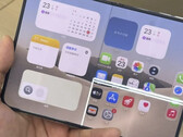 iPhone Duo unfolded with a bright horizontal line across its inner display.