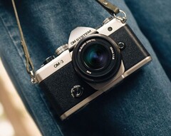 OM System OM-3 camera in silver and black