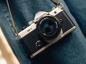 OM System OM-3 camera in silver and black