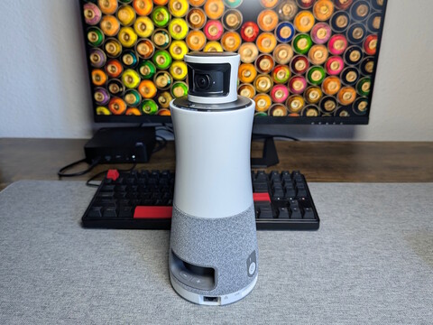 Ricoh Meeting 360 in front of a keyboard and monitor